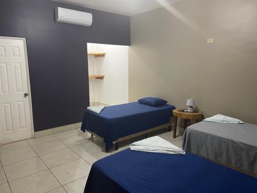 a hospital room with two beds and a door at RodMar Hotel in El Cuco