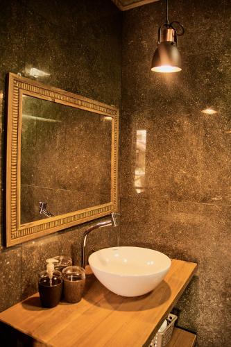 a bathroom with a sink and a mirror at Casa do Sossego in Florianópolis