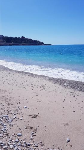 a sandy beach with rocks and the ocean at Monte Liza in Dobra Voda