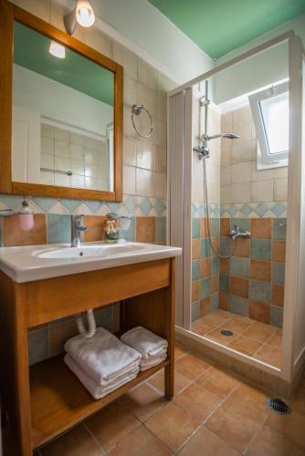 a bathroom with a sink and a shower at Rodi-Poros Green Village in Mikros Gialos