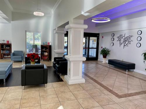a lobby with couches and chairs in a building at Days Inn & Suites by Wyndham Lakeland in Lakeland