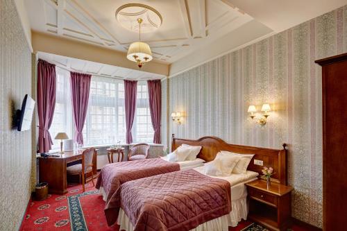 Postel nebo postele na pokoji v ubytování Hotel Atlas Deluxe