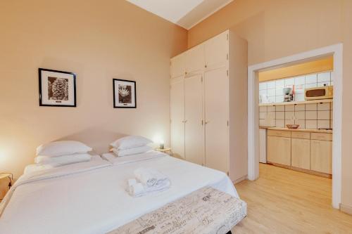 a bedroom with a large white bed with towels on it at ASPA - Alegria Studios in Funchal