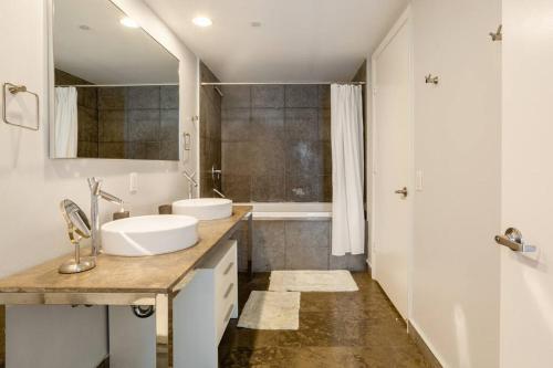 a white bathroom with two sinks and a tub at Downtown Miami Condo at the W - ICON Brickell in Miami