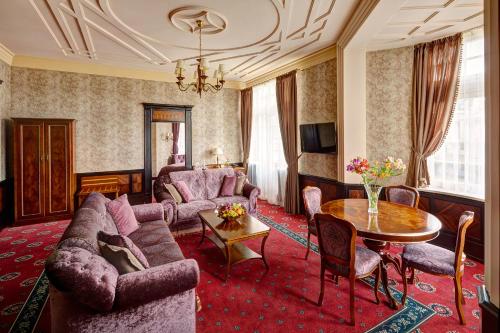 a living room with a couch and a table at Hotel Atlas Deluxe in Lviv