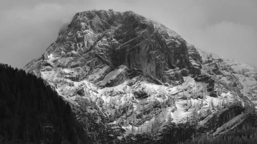 a large mountain with snow on the side of it at Landhaus Lilly in Obertraun