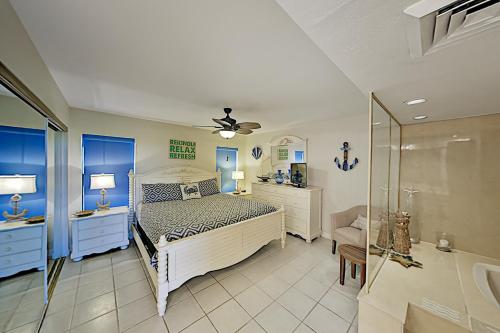 a bedroom with a bed and a glass shower at Mayan Princess Beach Condos in Padre Island