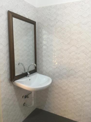 a bathroom with a sink and a mirror on the wall at Tayana place in Kizimkazi