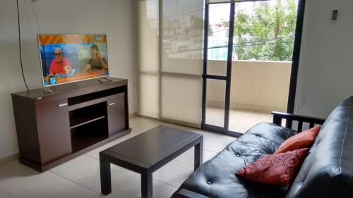 a living room with a couch and a table at Apartamento Esquiu C in Villa Carlos Paz