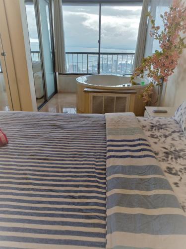 a bedroom with a bed with a view of the ocean at Panorama Bay View 3 room in Haifa