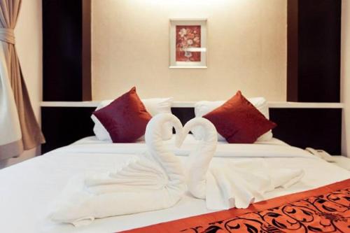 En eller flere senge i et værelse på Excella Hotel
