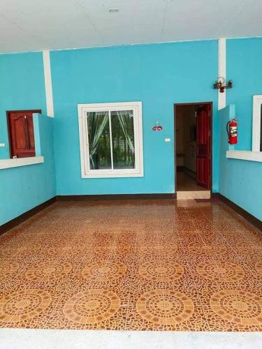 an empty room with blue walls and a blue floor at ณัฐชารีสอร์ท in Prachuap Khiri Khan