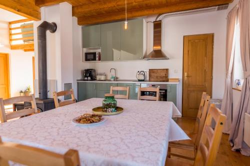 a kitchen with a table with a plate of food on it at Wooden Barn in Zăbala
