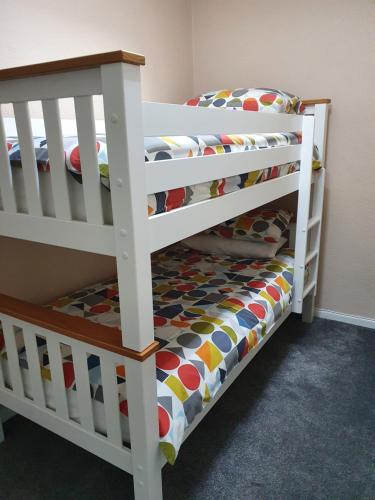 a white bunk bed in a childs bedroom at Chynoweth Court in Newquay