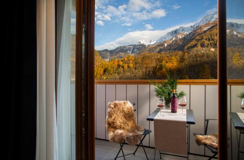 a balcony with a table and two glasses of wine at Hotel Tremoggia in Chiesa in Valmalenco