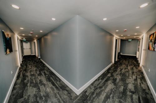 an empty hallway with a large white wall at Business Life Hotel & SPA Bakırköy in Istanbul
