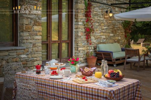 a table with a table cloth with food on it at B&B Santa Libera in Monastero Bormida