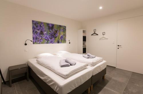 En eller flere senge i et værelse på Vakantiewoning Trimaarzate