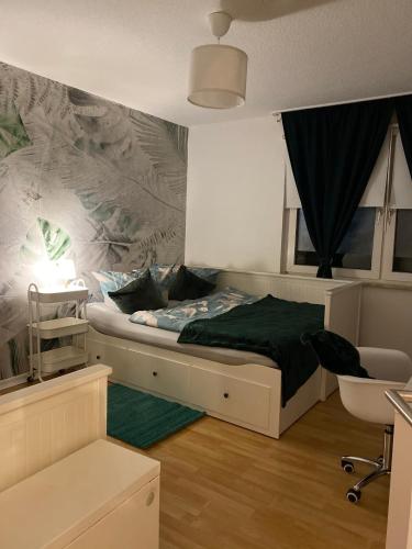a bedroom with a bed and a wall with a mural at Daheim in Essen in Essen