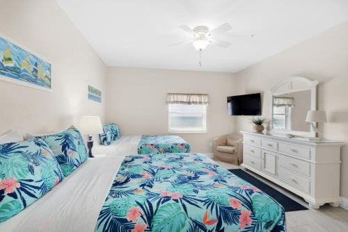 a bedroom with a bed and a dresser at Villas on the Gulf unit M5 in Pensacola Beach