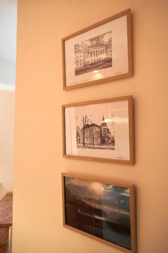 three framed pictures hanging on a wall at Apartament Sybiraków in Białystok
