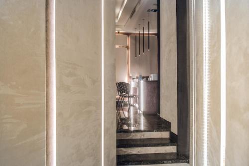 two pictures of a hallway with a staircase and a room at Doria Palace Boutique Hotel in Rome