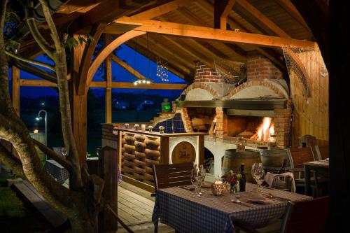 a dining table with a fireplace in a restaurant at Glamping Mountain Fairy Tale in Bistrica pri Tržiču