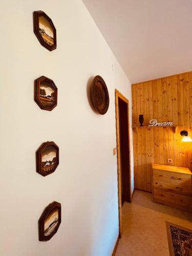 a room with a white wall with pictures on the wall at Alpenpension Gasthof in Ratten