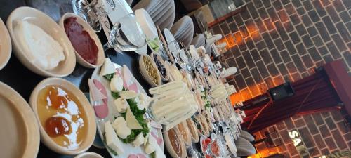 a table topped with plates and bowls of food at The Green Park Diyarbakir in Diyarbakır
