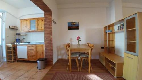 a kitchen with a table and a table and chairs at Apartman Mijo 1 in Jadranovo