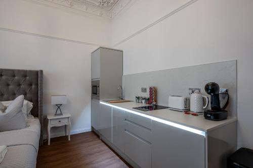a kitchen with a counter and a couch in a room at Casa Fresa - Orchar Suites in Broughty Ferry