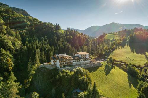 an aerial view of a house on a mountain at Rohrmooser Schlössl in Schladming