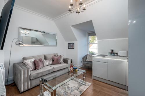 a living room with a couch and a kitchen at Casa Fresa - Orchar Suites in Broughty Ferry