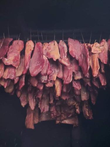 a bunch of meat hanging from a stick at Etno kuća Ostrvica in Varnice