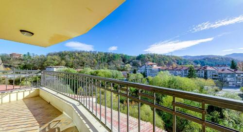 an apartment balcony with a view of the mountains at Troyan Plaza Hotel in Troyan