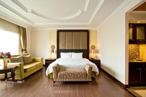 a hotel room with a bed and a couch at LK Residence in Pattaya Central