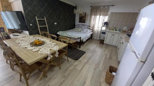 a kitchen and dining room with a table and chairs at Paradise House in Majdal Shams