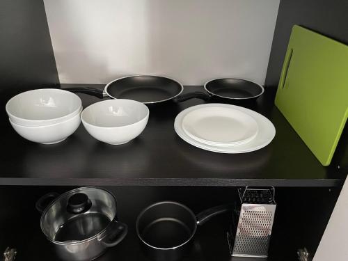 a black counter with three bowls and plates on it at En Passant / a time in Iasi in Iaşi