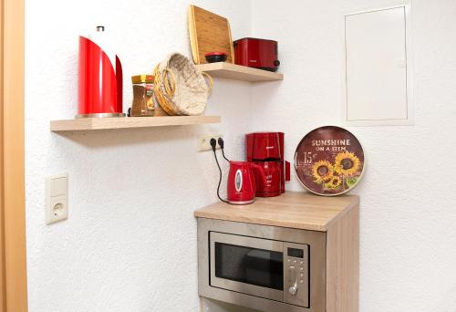 a kitchen with a microwave on top of a counter at Ferienwohnung Familie Leinweber in Waren