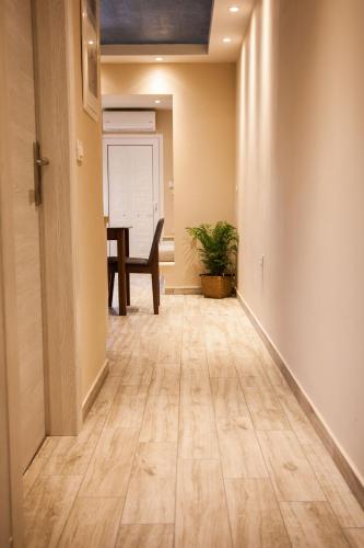 an empty hallway with a table and a chair at Paporas Apartments in Svoronata