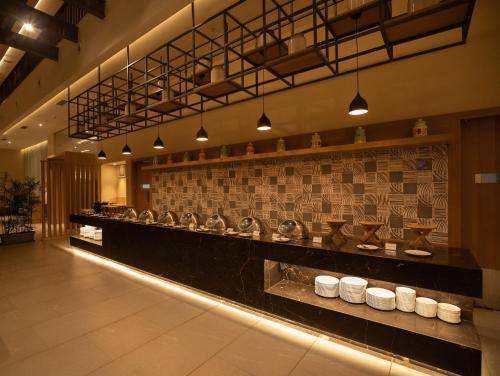a restaurant with a counter with bowls on it at The Vern at BLVD in Nashik