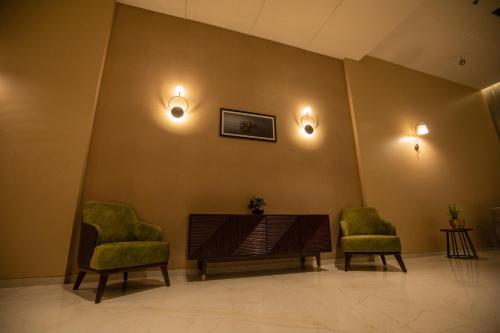 a waiting room with two chairs and a table at The Vern at BLVD in Nashik