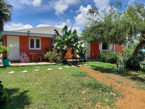 a house with a yard in front of it at Colibri Garden in Baie-Mahault