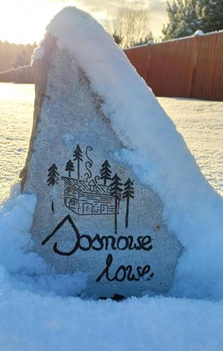 a rock covered in snow with the words roommate love at sosnowelowe in Lamkowo