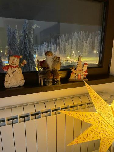 a window sill with christmas ornaments and a star at Planinski vrhovi Jelač in Kopaonik