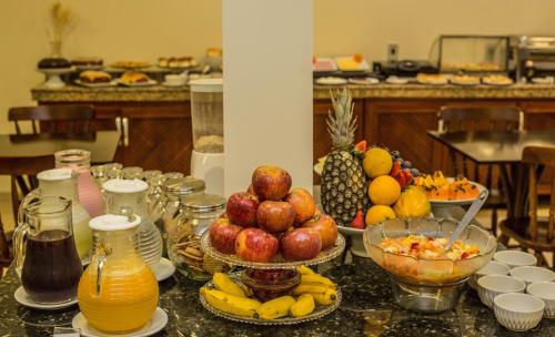 a table with a bunch of fruit on it at Hotel Monte Carlo in Uruguaiana