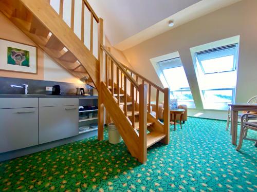 a kitchen and a staircase in a room at Hotel am Müritz-Nationalpark in Waren