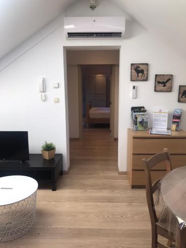a living room with a table and a dining room at Logement cosy à Durbuy in Durbuy