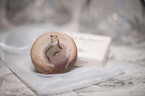 a chocolate covered donut sitting on a piece of paper at Adaastra Boutique Hotel in Naters