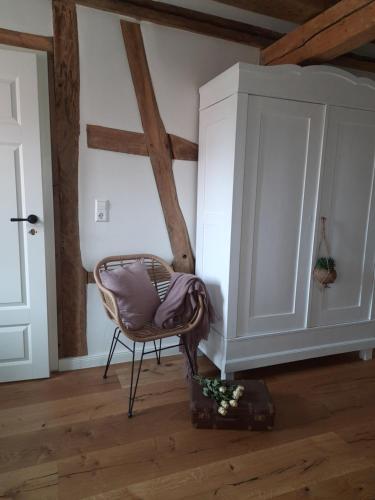 a room with a chair and a cabinet at BEAS WOHNEN in Sinsheim